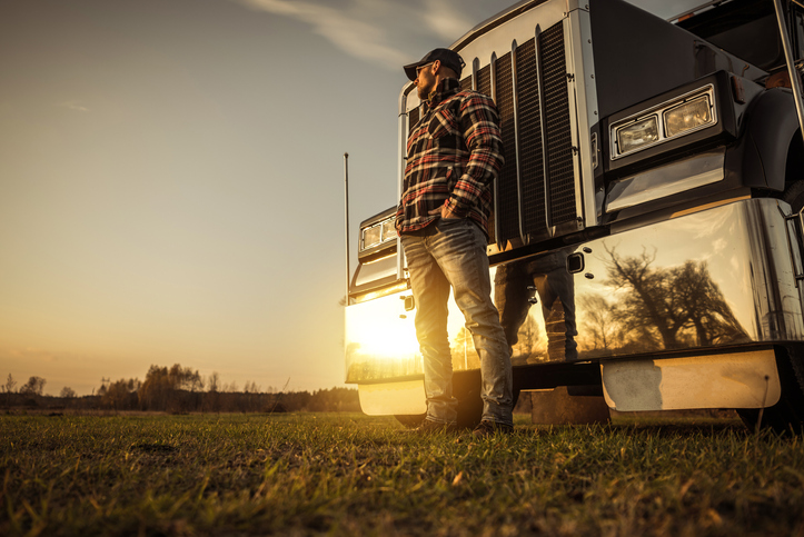 Trucker in Front of His Semi Truck During Sunset - Non-forced Dispatch